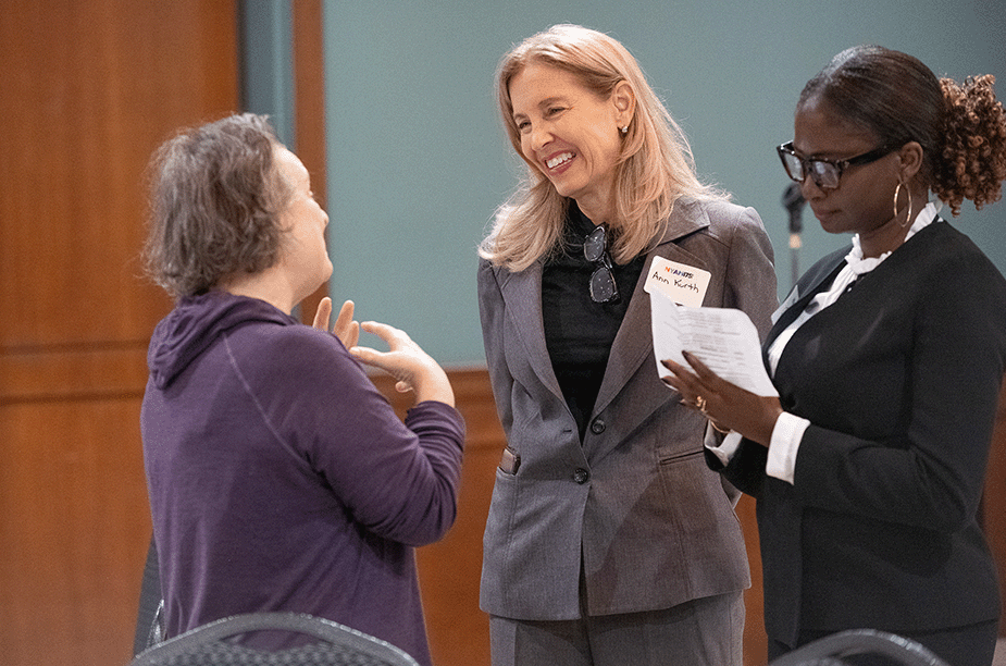 President Ann Kurth talking to a guest